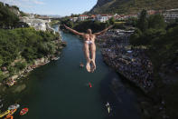 A diver jumps from the Old Bridge during the 456th traditional annual high diving competition in Mostar, Bosnia, Sunday, July 31, 2022. A total of 31 divers from Bosnia and region leapt from the 23-meter-high bridge into the Neretva River. (AP Photo/Armin Durgut)