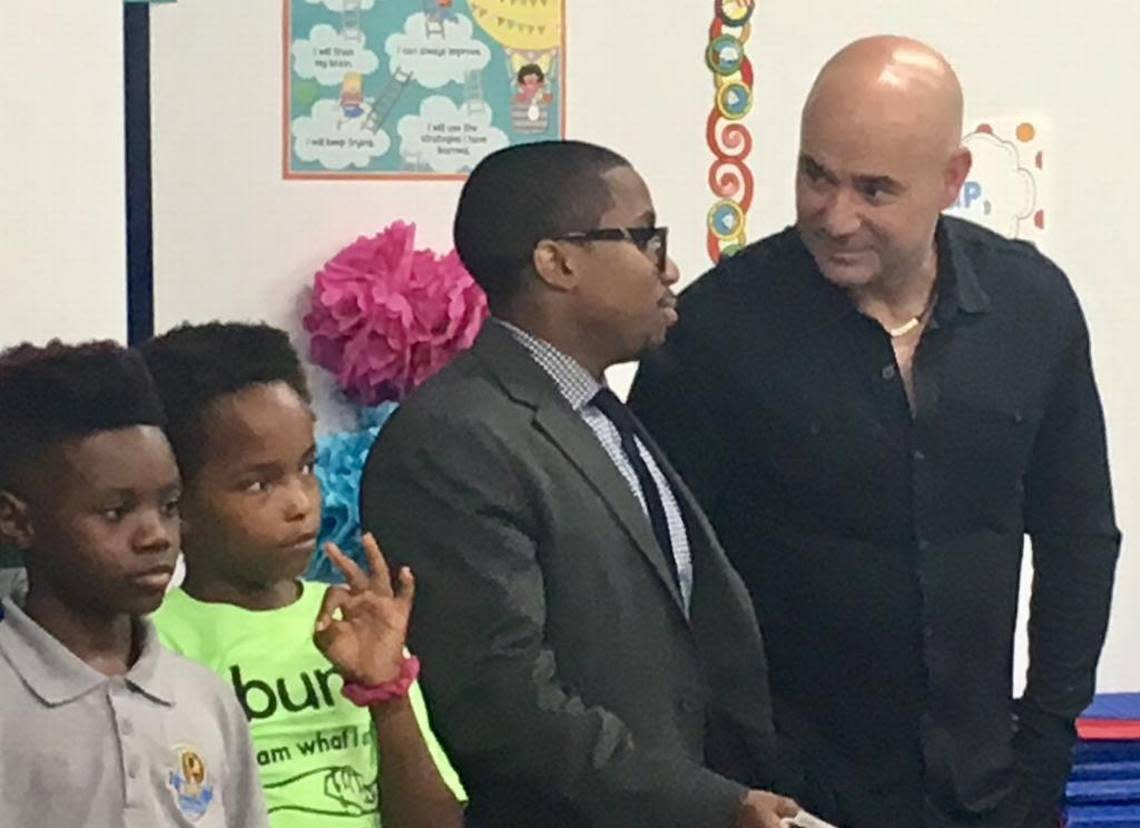 Andre Agassi, right, talks with administrators and students at the KIPP Change Academy school in east Charlotte in 2017. Agassi, a former tennis star, has helped build charter schools across the United States.