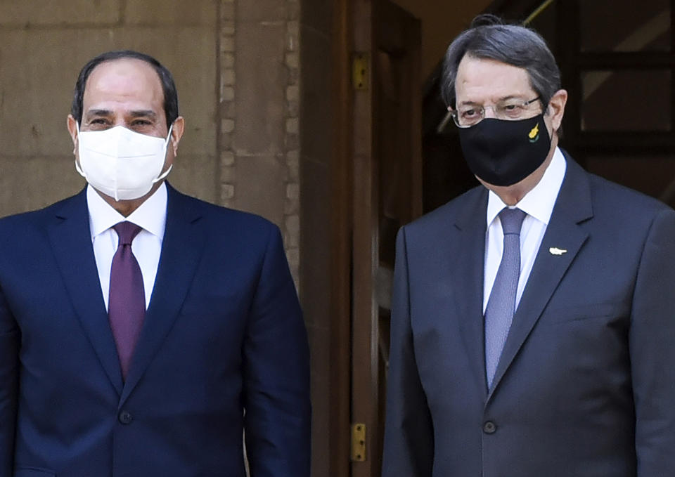 Cyprus President Nicos Anastasiades, right, welcomes the Egypt's President Abdel-Fattah el-Sissi following their meeting at the presidential palace in capital Nicosia, Cyprus, on Wednesday, Oct. 21, 2020. The leaders of Cyprus, Egypt and Greece meet in the Cypriot capital for talks on forging closer ties and boosting cooperation on issues including energy following the discovery of gas deposits in the east Mediterranean. (Iakovos Hatzistavrou Pool via AP)