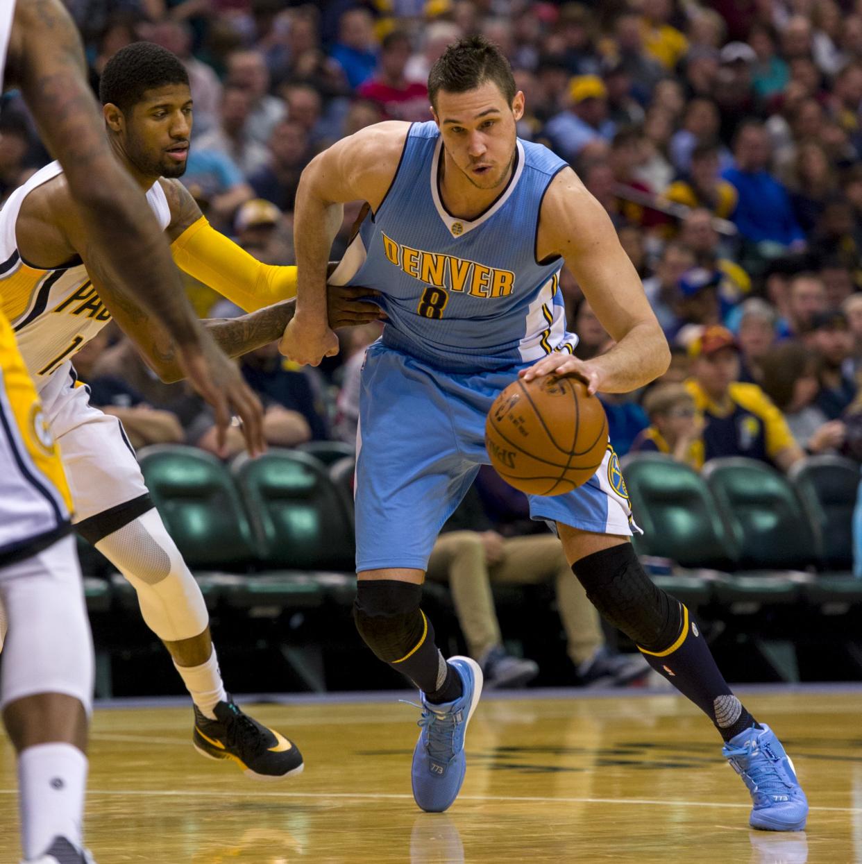 Denver Nuggets forward Danilo Gallinari tries to dribble past the defense of Indiana Pacers forward Paul George during a Jan. 30, 2016, game. (AP/Doug McSchooler)