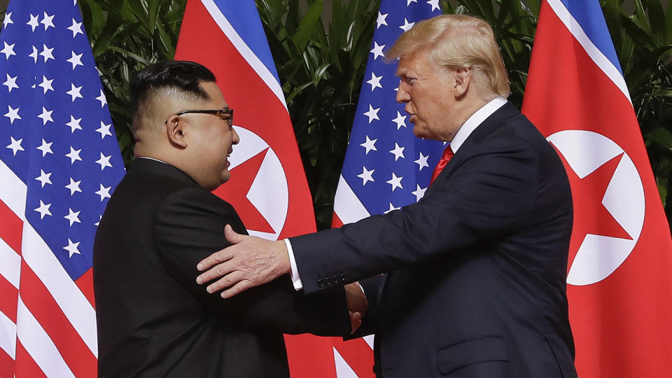 President Trump shakes hands with North Korea leader Kim Jong Un.