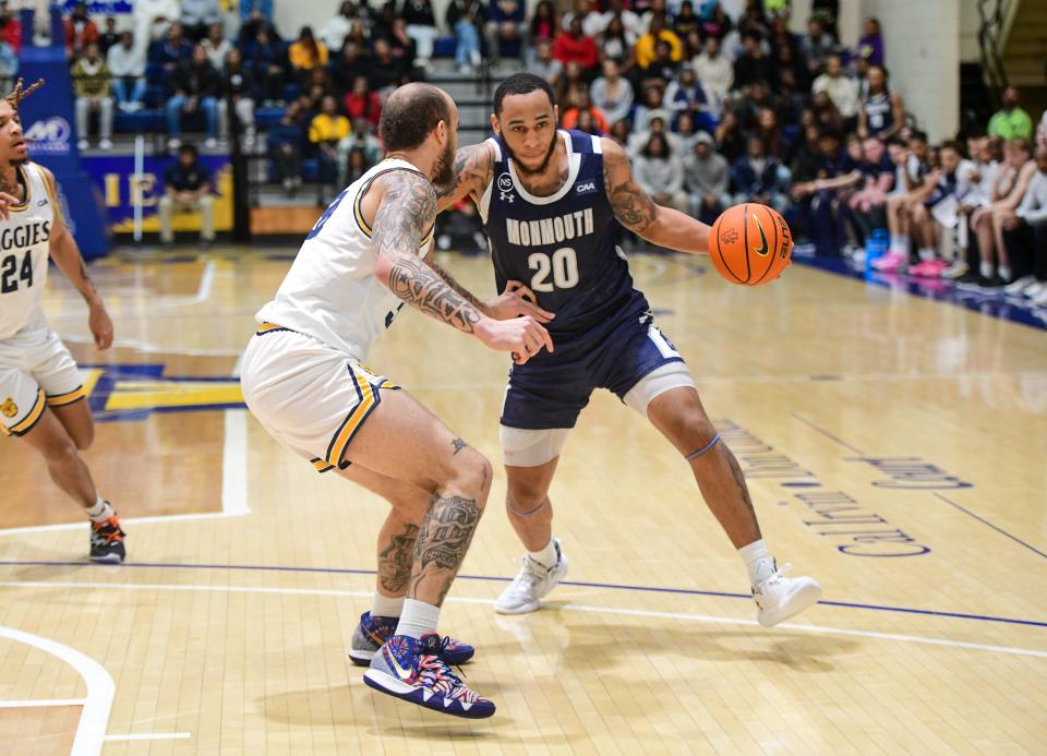 Monmouth's Tahron Allen drives against North Carolina A&T's Duncan Powell on Jan. 28, 2023 in Greensboro, North Carolina.