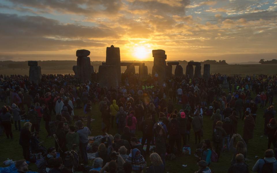 Summer solstice at Stonehenge, with the sun rising in the distance. - Credit: Paul Grover for the Telegraph