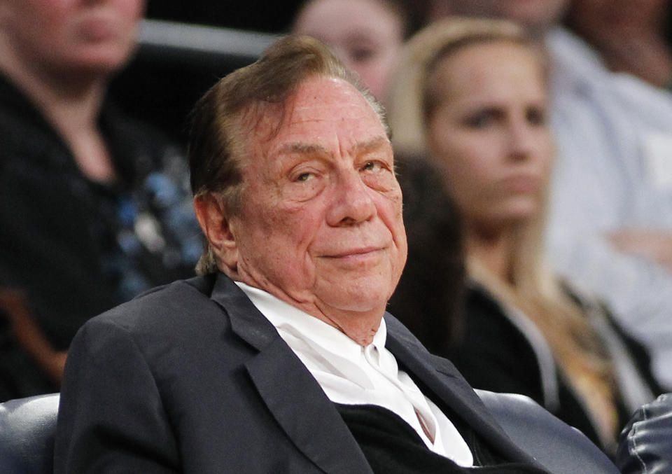 FILE- This is a Dec. 19, 2011 file photo shows Los Angeles Clippers owner Donald Sterling watching the Clippers play the Los Angeles Lakers during an NBA preseason basketball game in Los Angeles. The former became the first person banned by NBA Commissioner Adam Silver in 2014 for violating league rules. (AP Photo/Danny Moloshok, File)