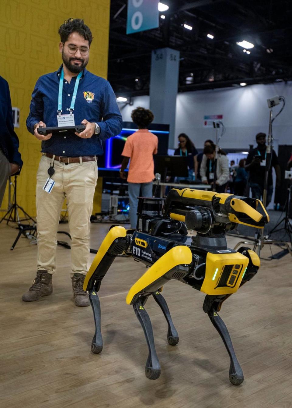 A robotic dog affectionately called Sunshine is put to the test in the FIU booth at eMerge Americas conference on April 20, 2023.