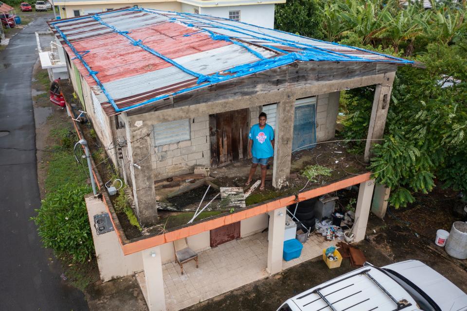 Jetsabel Osorio stands in her house damaged five years ago by Hurricane Maria before the arrival of Tropical Storm Fiona in Loiza, Puerto Rico, Saturday, Sept. 17, 2022.