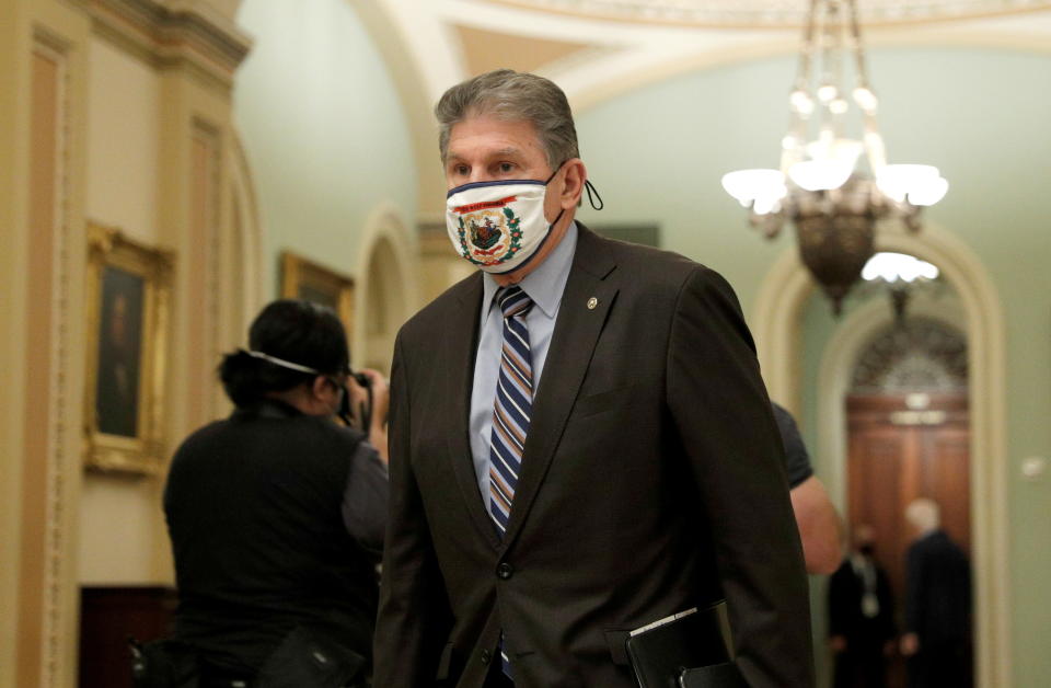 Sen. Joe Manchin walks through the Capitol wearing a face mask