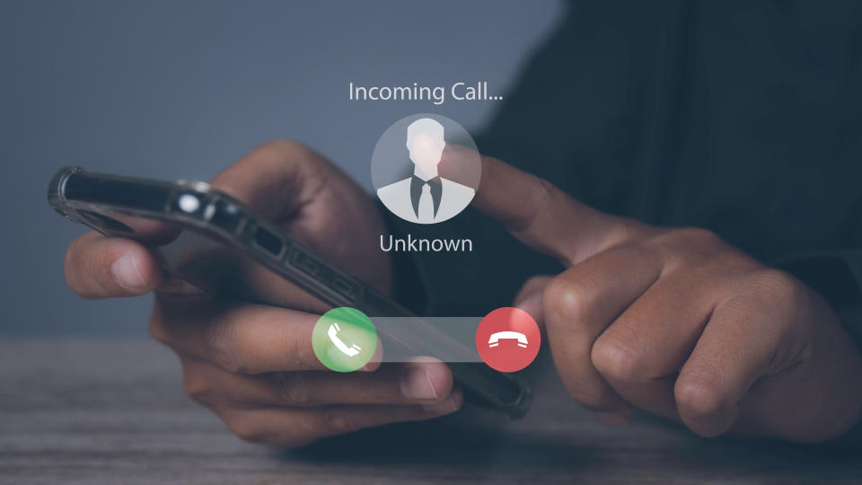  Phone scam showing an unknown caller on a phone screen. 