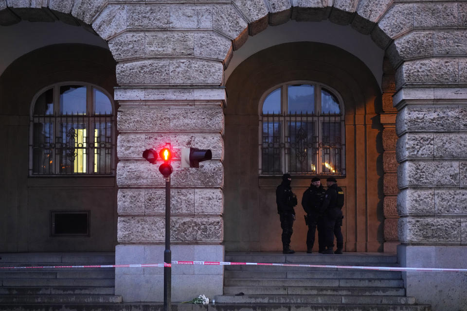 Policemen guard the area outside the building of Philosophical Faculty of Charles University Prague, Czech Republic, Friday, Dec. 22, 2023. A lone gunman opened fire at a university on Thursday, killing more than a dozen people and injuring scores of people. (AP Photo/Petr David Josek)