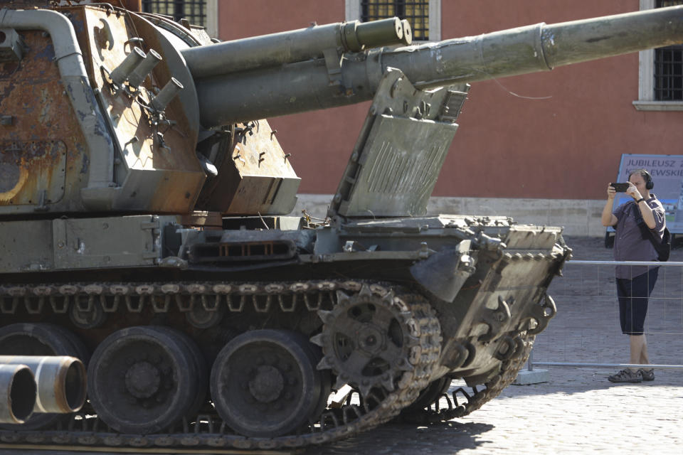 People visit an open-air exhibition of damaged and burnt-out Russian tanks and armored vehicles at the Castle Square, in Warsaw, Poland, Monday, June 27, 2022. The vehicles were captured by Ukrainian military forces during the war in the Ukraine. Ukrainian authorities announced that there are plans for similar exhibits in other European capitals such as Berlin, Paris, Madrid and Lisbon. (AP Photo/Michal Dyjuk)