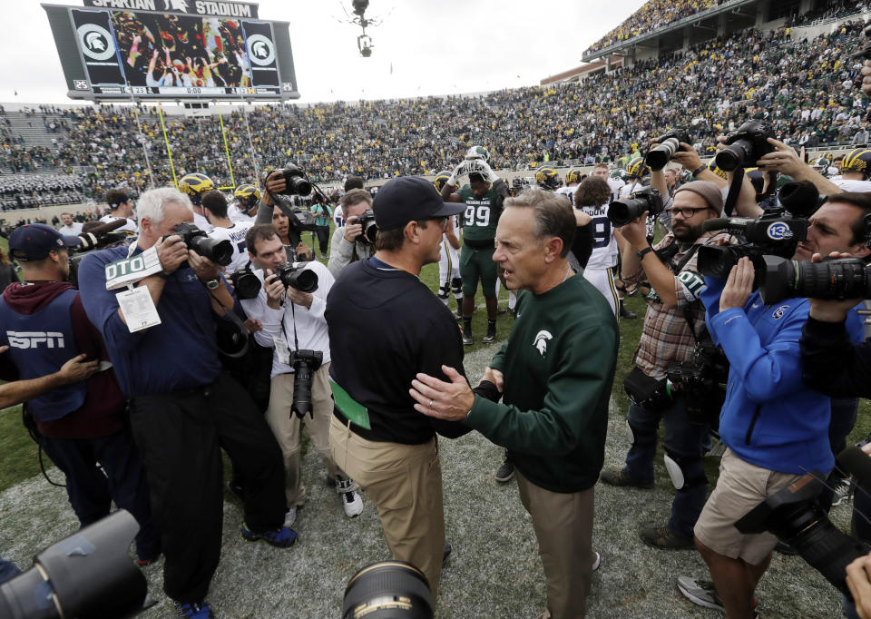 Michigan is heading to the Outback Bowl while Michigan State — with a better record — is going to the Holiday Bowl. (AP Photo/Carlos Osorio, File)