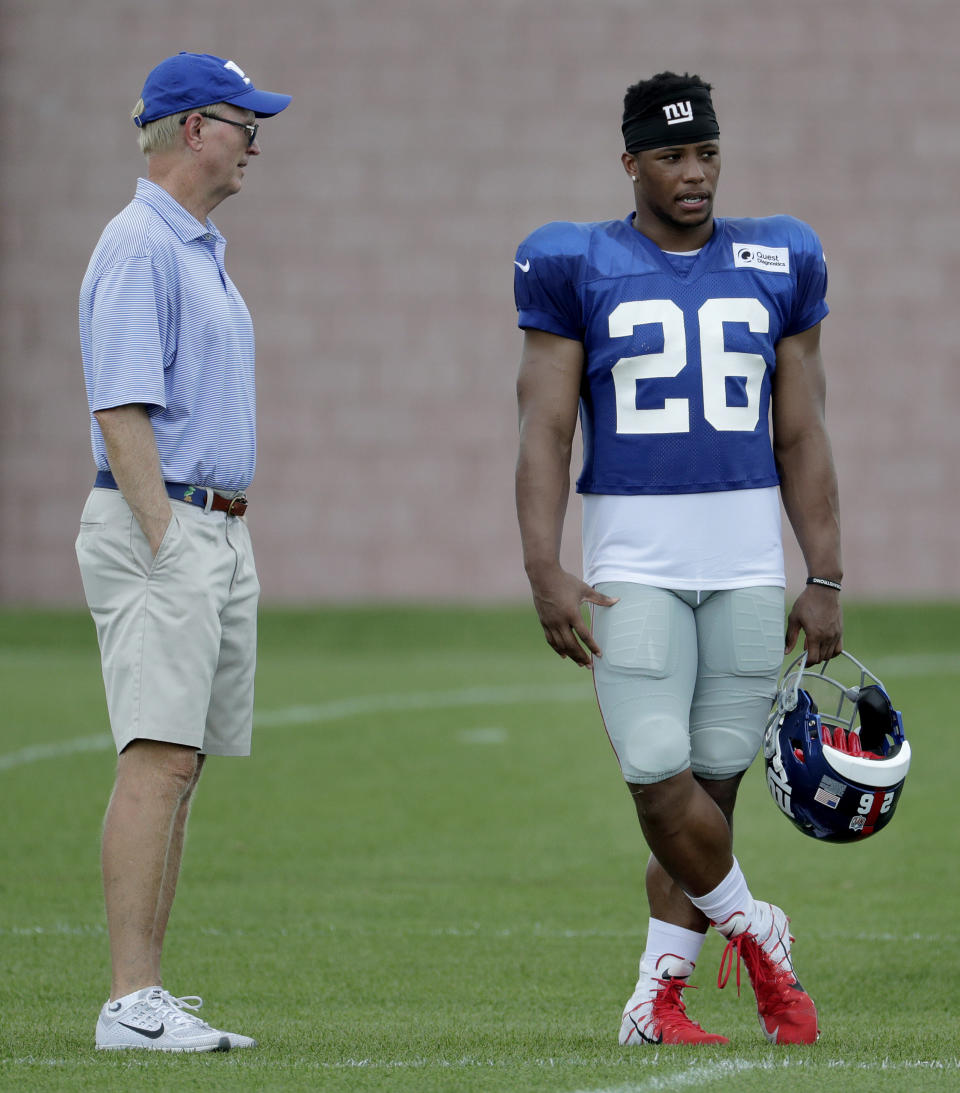 New York Giants owner John Mara, left, talks to running back Saquon Barkley during NFL football training camp, Thursday, Aug. 2, 2018, in East Rutherford, N.J. (AP Photo/Julio Cortez)