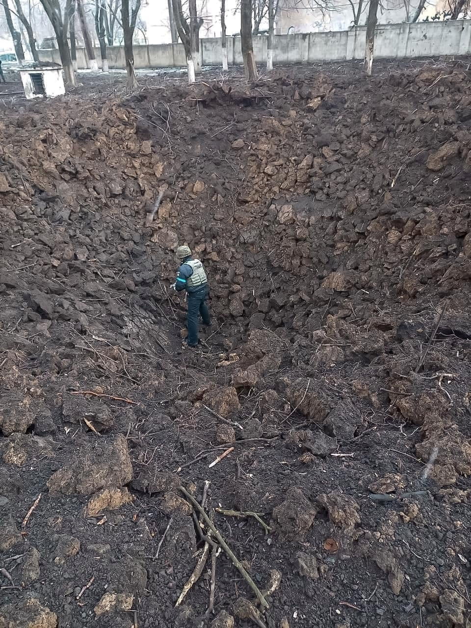 A sapper of the State Emergency Service stands at the bottom of a bomb crater amid Russia's invasion of Ukraine, in Mariupol, Ukraine, in this handout picture released March 9, 2022.  Press service of the National Police of Ukraine/Handout via REUTERS ATTENTION EDITORS - THIS IMAGE HAS BEEN SUPPLIED BY A THIRD PARTY.