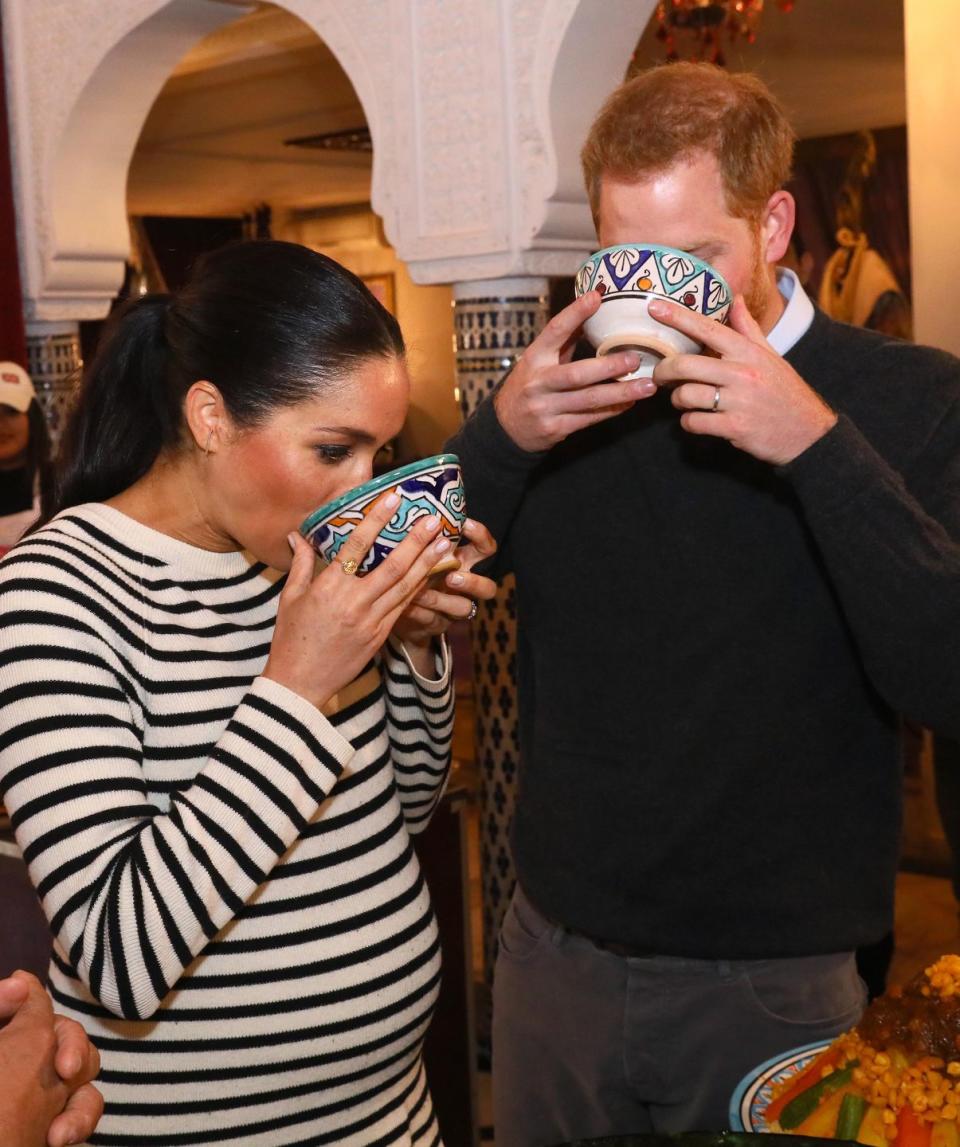 The Duke and Duchess of Sussex sample the food during a cooking demonstration.