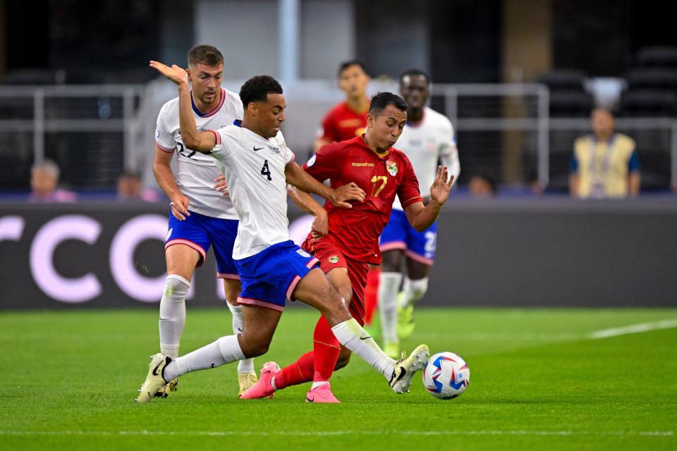 The USMNT's Tyler Adams (4) knocks the ball away from Bolivia's Miguel Terceros during the first half at AT&T Stadium.