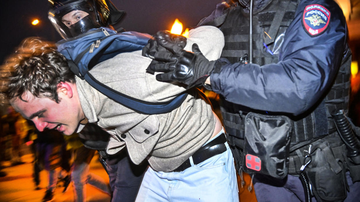 Police officers detain a man in Moscow