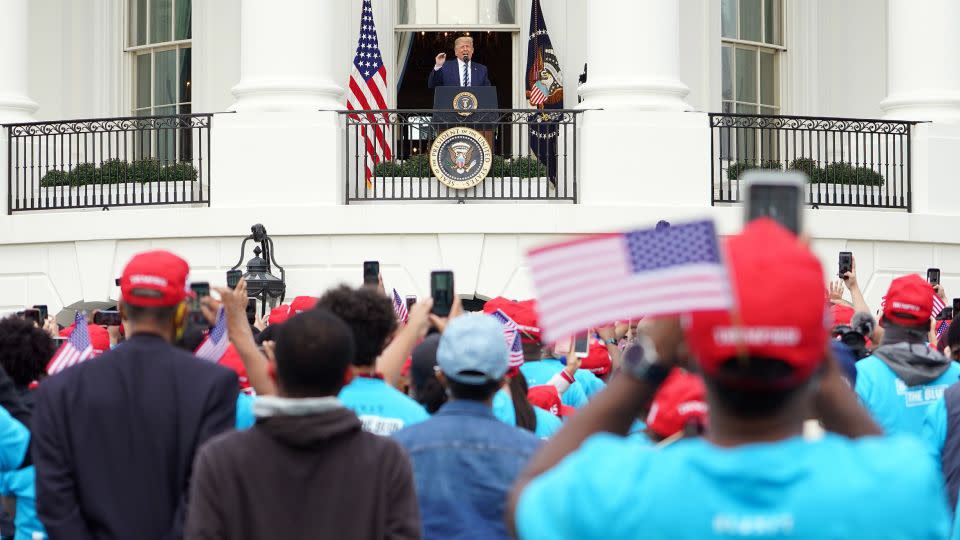 Then-President Donald Trump speaks to supporters at White House on October 10, 2020. The speech was his first public address since he'd tested positive for Covid-19. - Mandel Ngan/AFP/Getty Images/File