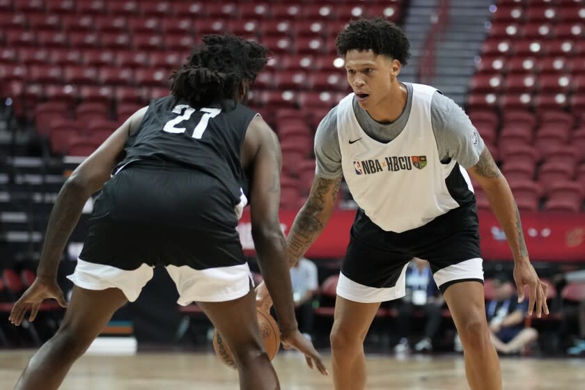 Najee Garvin, right, plays against Jeremy Combs during a basketball game at an HBCU Showcase at the NBA summer league Monday, July 11, 2022, in Las Vegas. (AP Photo/John Locher)