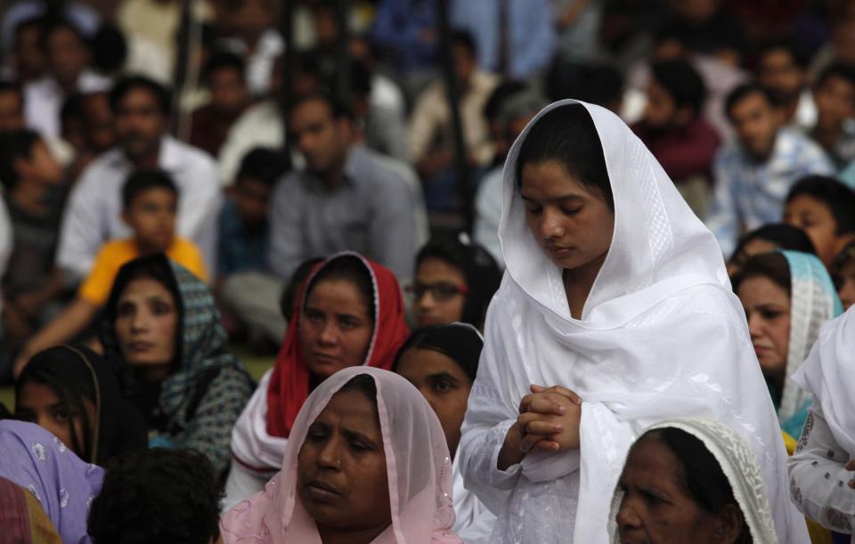 A Pakistani Christian woman attends a Good Friday service with others at the Saint Anthony Church in Lahore April 18, 2014. Holy Week is celebrated in many Christian traditions during the week before Easter.