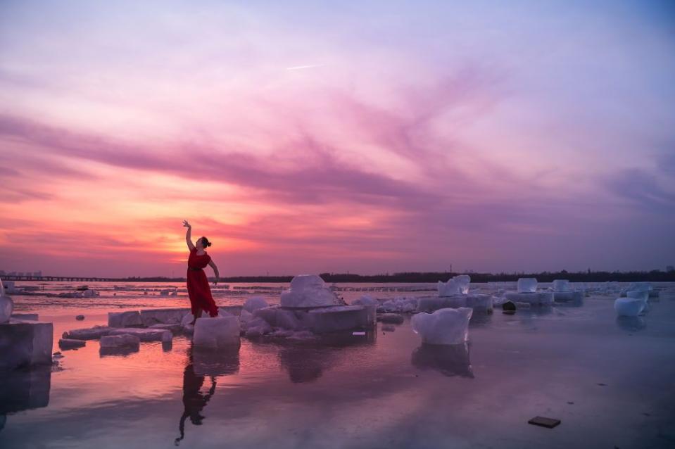<p>A woman performs a dance of spring standing amid ice and snow on Songhua River in Harbin, Heilongjiang Province, China // February 24, 2019</p>