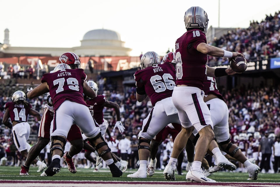 Troy quarterback Gunnar Watson (18) works in the pocket against the Louisiana-Lafayette during the first half of an NCAA college football game, Saturday, Nov. 18, 2023, in Troy, Ala. (AP Photo/Mike Stewart)