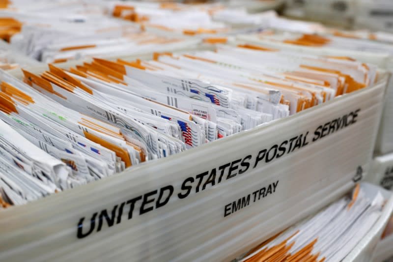 FILE PHOTO: Mail-in ballots for the upcoming congressional election in Orange County wait to be inspected by election workers at the Orange County Registrar of Voters in Santa Ana, California