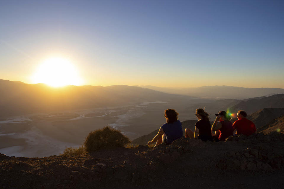 Park visitors watch the sunset on Tuesday, July 11, 2023, in Death Valley National Park, Calif. July is the hottest month at the park with an average high of 116 degrees (46.5 Celsius). (AP Photo/Ty ONeil)