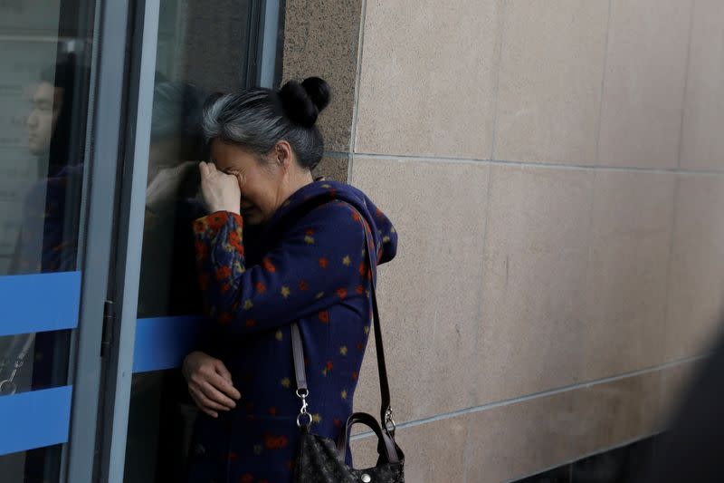 A relatives of a passenger aboard Malaysia Airlines flight MH370 reacts as she waits for a state representative ouside the Chinese ministry of foreign affairs in Beijing