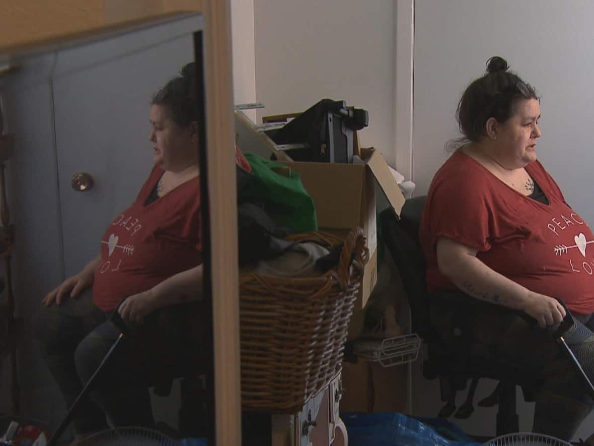 Samantha Andrews sat in her former NDG apartment for the last time on Saturday, as neighbours cleared the apartment helping her with the move.   (CBC News - image credit)