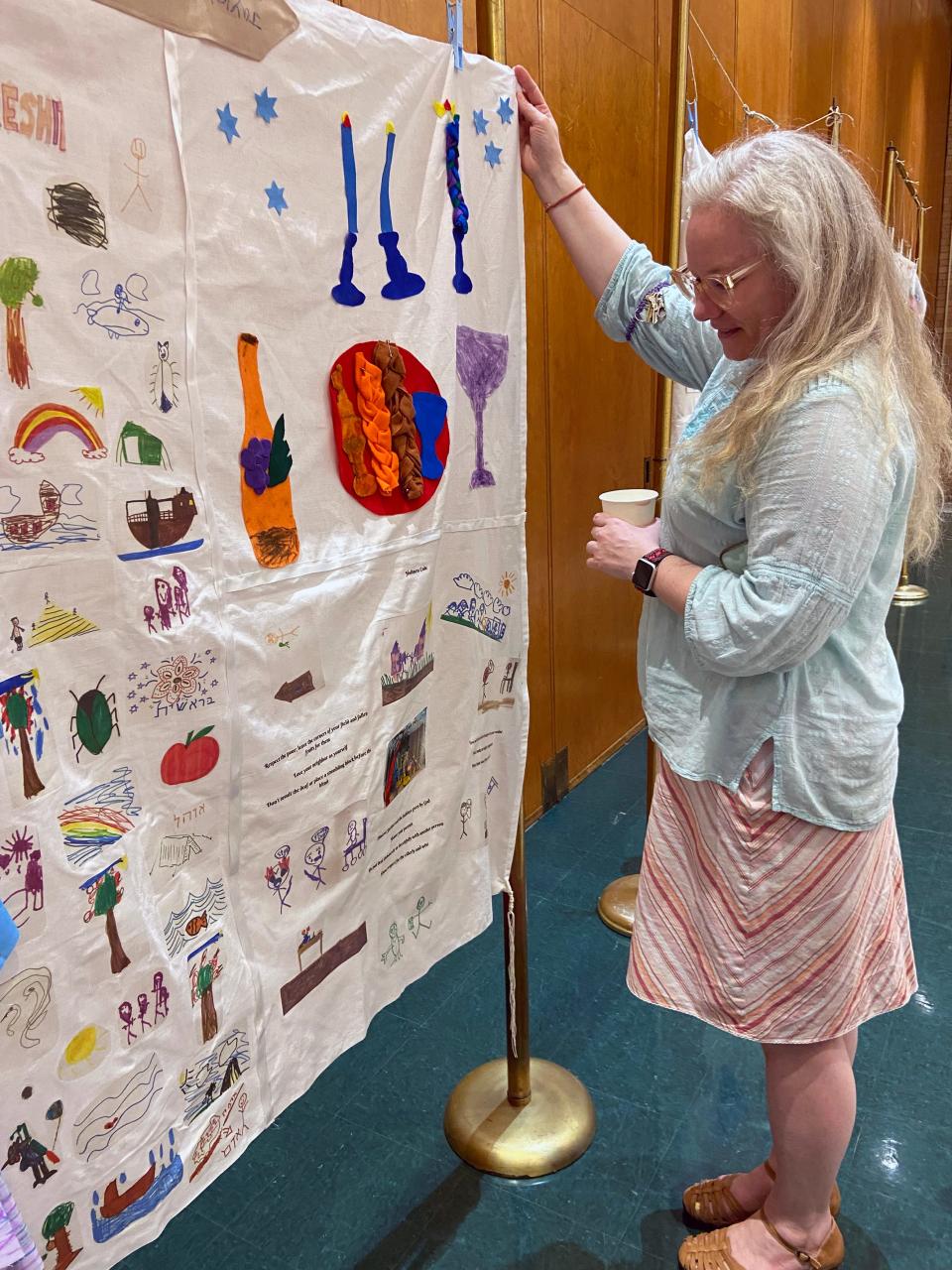Ardis Steele, Temple B'nai Israel youth engagement specialist, shows Torah youth crafts on display during the Shavuot campout at Temple B'nai Israel in Oklahoma City.