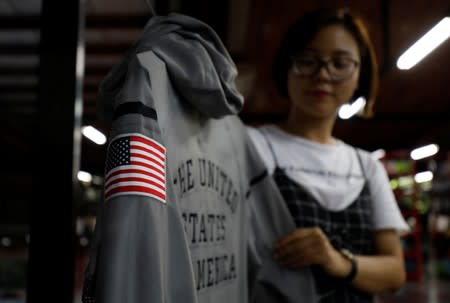 An employee shows a Nike's jacket for USA Olympic 2012 team which was produced by Maxport garment company at its headquarters in Hanoi