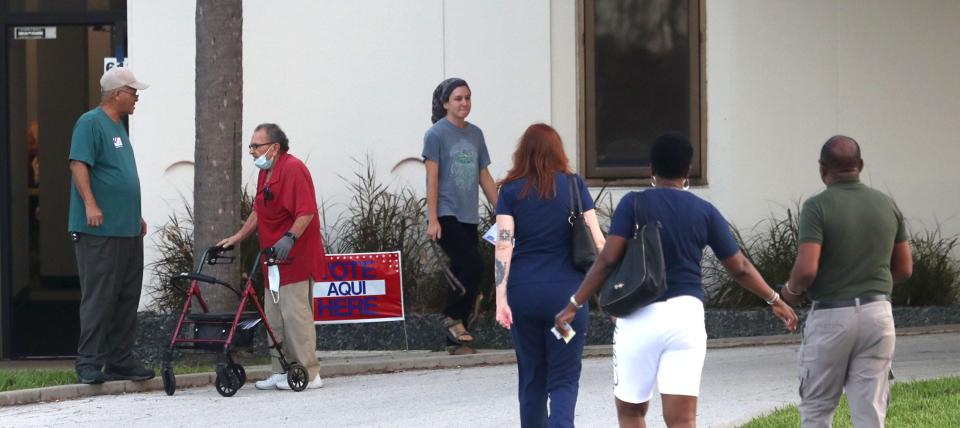 Voters make their way to the cast ballots in Tuesday's primary election at City Island Library in Daytona Beach. “It’s our responsibility as Americans," said David Butts, 54, among he first to arrive when the polls opened at 7 a.m.