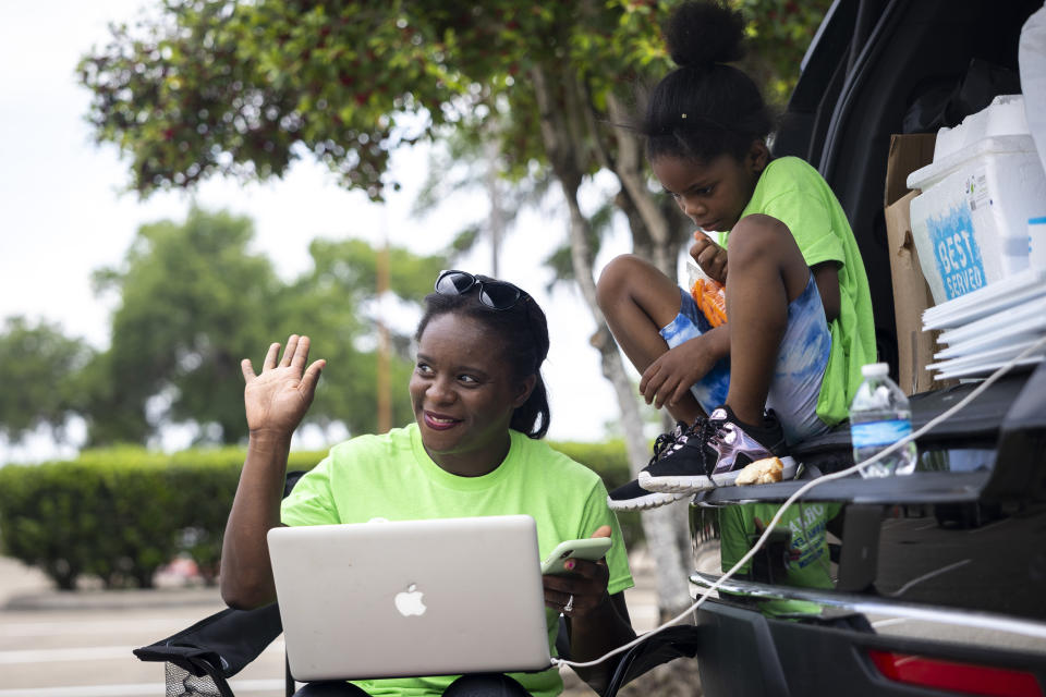 School board trustee hopeful Orjanel Lewis waves to supporters as she teaches the last legal writing course of the semester while campaigning on Election Day on May 7, 2022, in Ft. Bend County, Texas. (Annie Mulligan for NBC News)