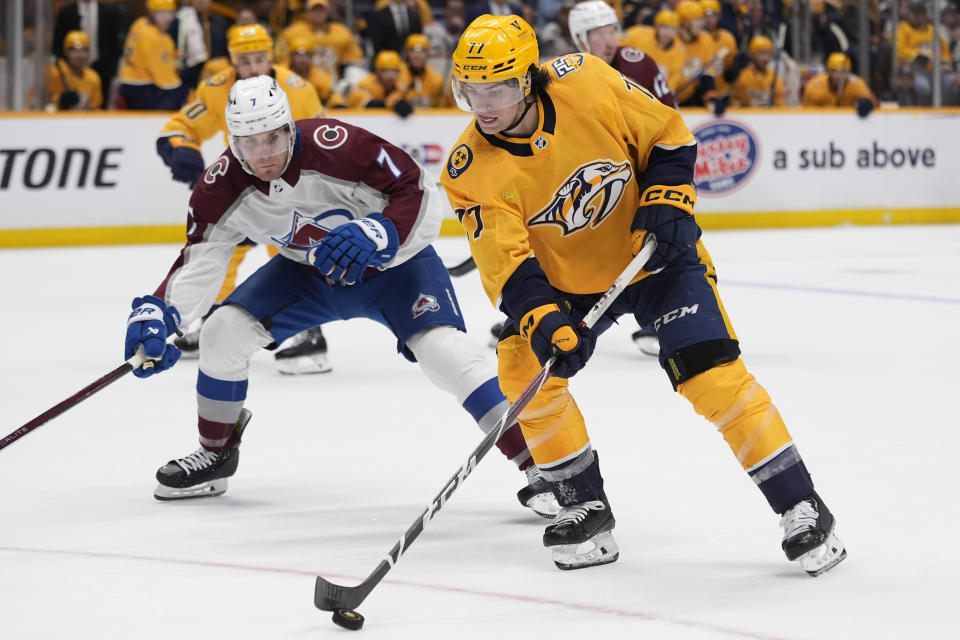 Nashville Predators right wing Luke Evangelista (77) skates the puck past Colorado Avalanche defenseman Devon Toews (7) during the second period of an NHL hockey game Saturday, March 2, 2024, in Nashville, Tenn. (AP Photo/George Walker IV)