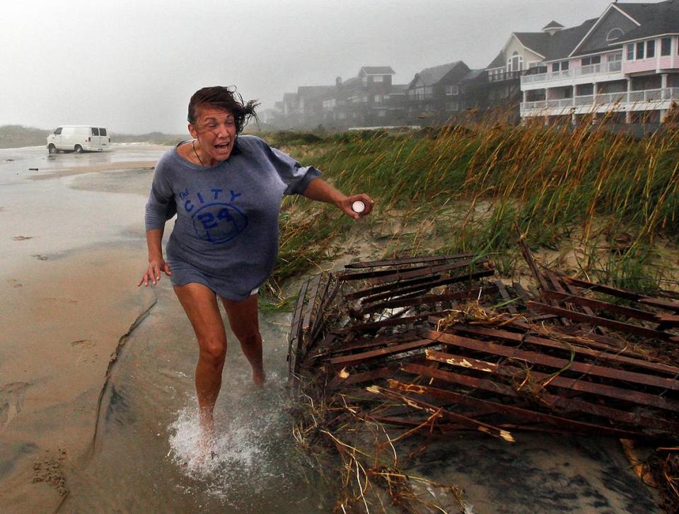 Jackie Sparnackel abandons her van and her belongings near the Frisco Pier after overwash stranded her vehicle as the wind and rain of Hurricane Irene batters the Outer Banks.