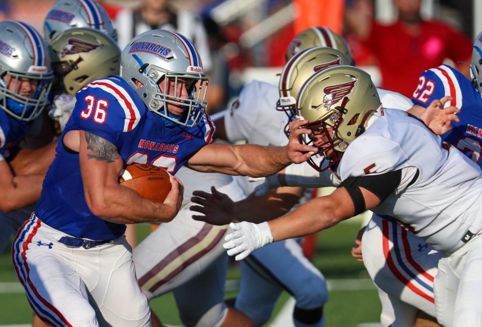 Marysville's Colton Powers carries the ball against New Albany on Aug. 19.