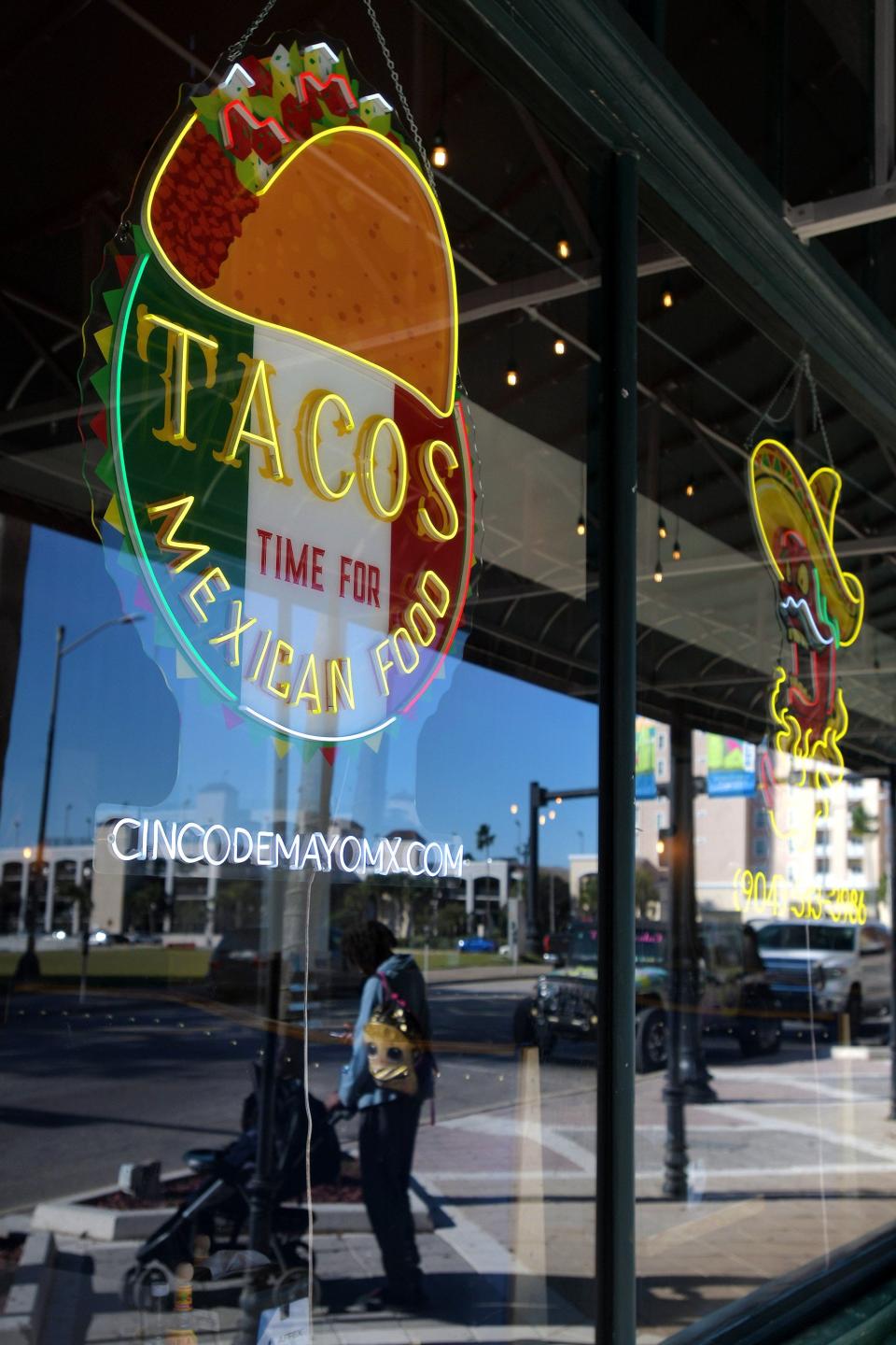The signage in the Bay Street windows of Cinco de Mayo on Feb. 21, 2024. Cinco de Mayo recently opened at 301 E. Bay St. Unit 1 in downtown Jacksonville.