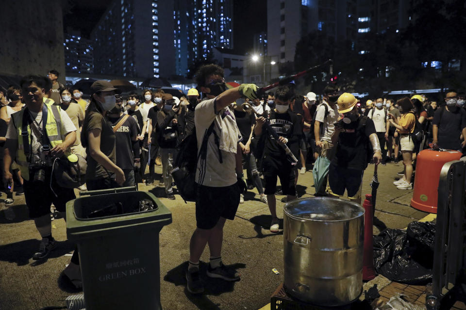 A protester shouts as hundreds of protesters gather outside Kwai Chung police station in Hong Kong, Tuesday, July 30, 2019. Protesters clashed with police again in Hong Kong on Tuesday night after reports that some of their detained colleagues would be charged with the relatively serious charge of rioting. (AP Photo/Vincent Yu)