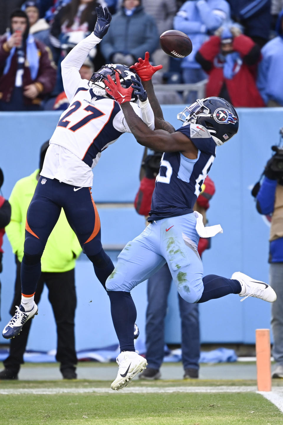 Denver Broncos cornerback Damarri Mathis (27) breaks up a pass intended for Tennessee Titans tight end Chigoziem Okonkwo (85) during the second half of an NFL football game, Sunday, Nov. 13, 2022, in Nashville, Tenn. The Tennessee Titans won 17-10. (AP Photo/Mark Zaleski)