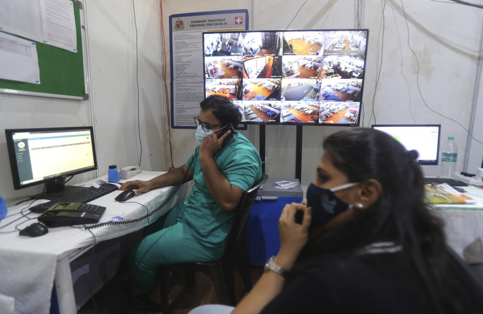 Senior consultants monitor and evaluate each patient's medical condition remotely in the war room of BKC jumbo field hospital, one of the largest COVID-19 facilities in Mumbai, India, Friday, May 7, 2021.(AP Photo/Rafiq Maqbool)