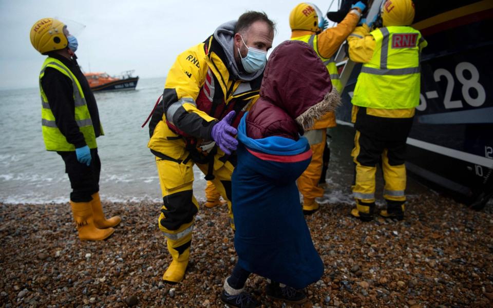 Migrants including children were helped ashore by the RNLI yesterday - Ben Stansall/AFP