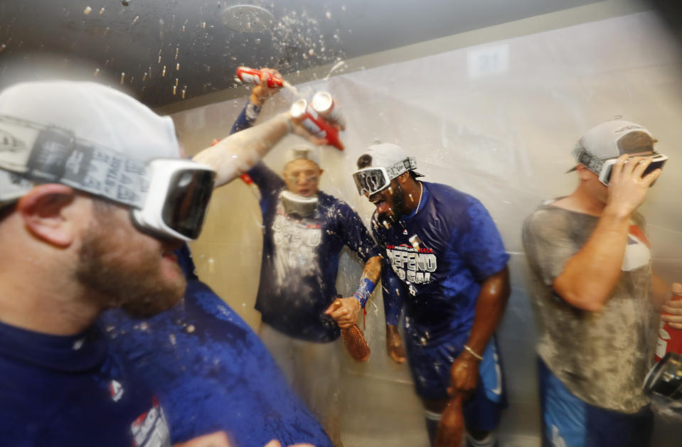 Los Angeles Dodgers' Yasiel Puig celebrates with teammates after clinching a playoff spot after beating the San Francisco Giants in a baseball game in San Francisco, Saturday, Sept. 29, 2018. (AP Photo/Jim Gensheimer)