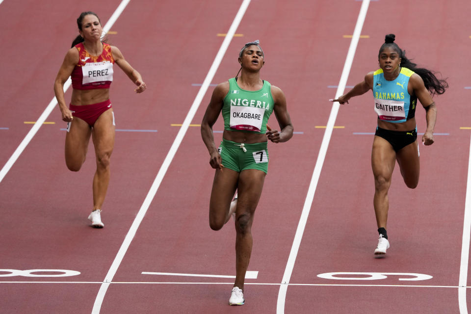 Blessing Okagbare, of Nigeria, wins a heat in the women's 100-meter run at the 2020 Summer Olympics, Friday, July 30, 2021, in Tokyo. (AP Photo/Charlie Riedel)