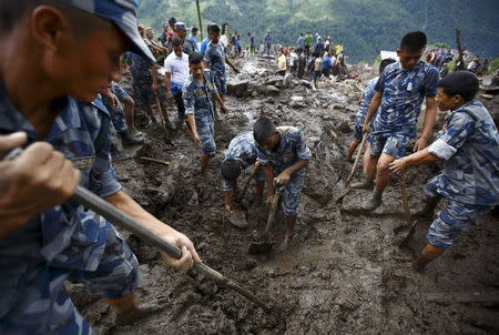 Rescue team members search for landslide victims at Lumle village in Kaski district July 30, 2015. REUTERS/Navesh Chitrakar