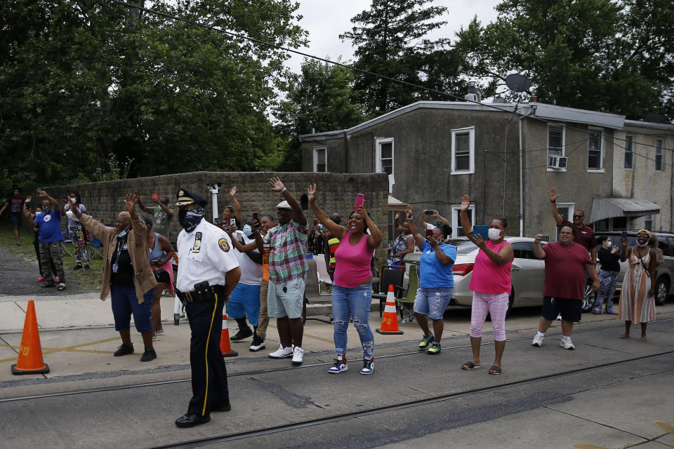 Residents cheer as the motorcade of Democratic presidential candidate, former Vice President Joe Biden departs after a speaking event, Wednesday, June 17, 2020, in Darby, Pa. (AP Photo/Matt Slocum)