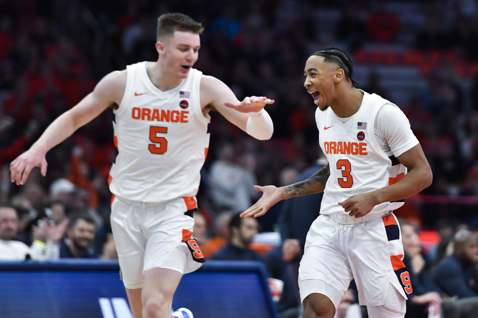 Syracuse guard Judah Mintz, right, celebrates with guard Justin Taylor after scoring against Virginia during the first half of an NCAA college basketball game in Syracuse, N.Y., Monday, Jan. 30, 2023. (AP Photo/Adrian Kraus)