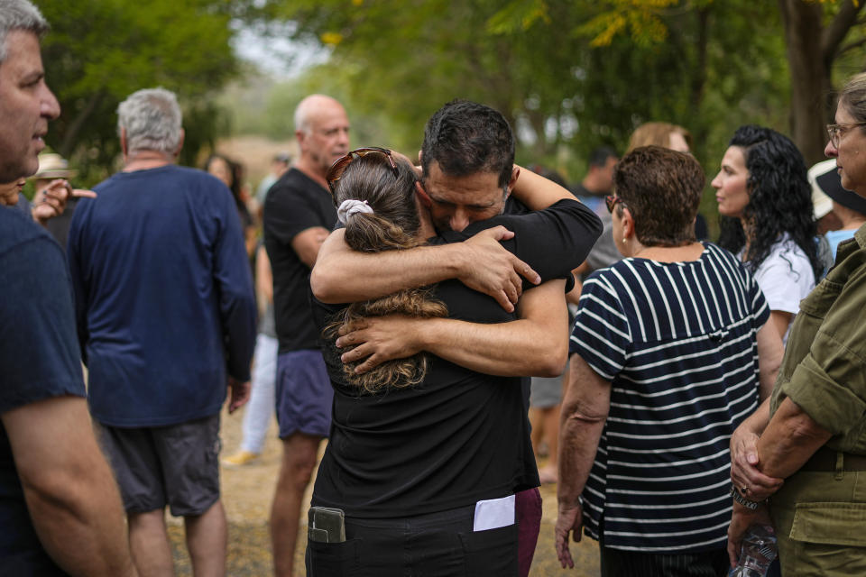 Friends and relatives of Roi Popplewell mourn during his funeral at Kibbutz Yagur near Haifa, northern Israel, Friday, Oct. 27, 2023. (AP Photo/Ariel Schalit)