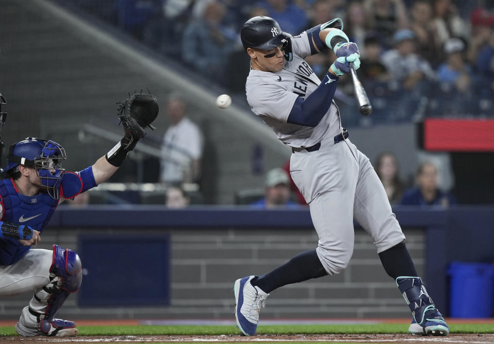 New York Yankees outfielder Aaron Judge (99) strikes out as Toronto Blue Jays catcher Danny Jansen (9) makes the catch during the first inning of a baseball game in Toronto on Tuesday, April 16, 2024. (Nathan Denette/The Canadian Press via AP)