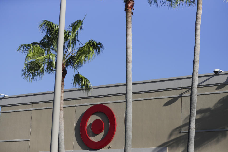 FILE - In this Oct. 3, 2018, file photo customers shop at a Target department store in Pembroke Pines, Fla. Target is launching a private food label next month as it attempts to energize grocery sales. On Sept. 15, 2019, 650 products will appear on store shelves under the brand “Good & Gather.” (AP Photo/Brynn Anderson, File)