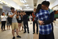 Pro-democracy candidate James Yu hugs his girlfriend after winning his seat in district council elections in Hong Kong, early Monday, Nov. 25, 2019. Vote counting was underway in Hong Kong on Sunday after a massive turnout in district council elections seen as a barometer of public support for pro-democracy protests that have rocked the semi-autonomous Chinese territory for more than five months. (AP Photo/Vincent Yu)